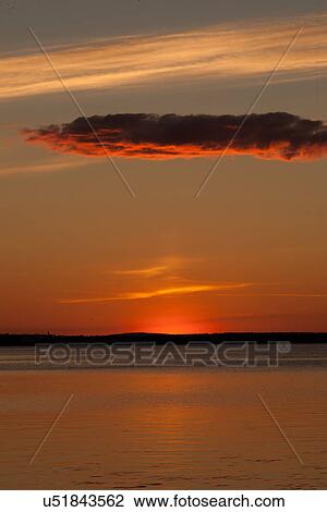 Stock Image - Sunset over water, Lulea, Lapland, Sweden. Fotosearch