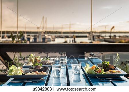 Table set with meals by marina, Reykjavik, Iceland View Large Photo Image Stock Image - Table set with meals by marina, Reykjavik, Iceland. Fotosearch
