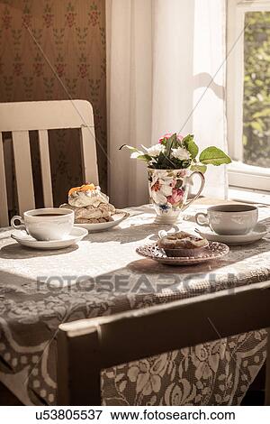 Table set with vintage vase, teacups and desserts View Large Photo Image Stock Photo - Table set with vintage vase, teacups and desserts. Fotosearch