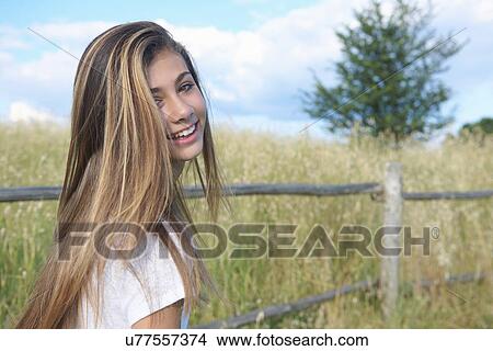Teenage girl by wooden fence, Tuscany, Italy View Large Photo Image Picture - Teenage girl by wooden fence, Tuscany, Italy. Fotosearch