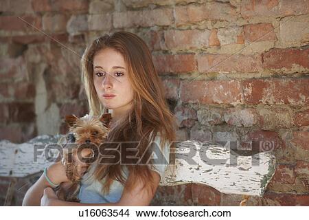 Picture - Teenage girl on bench with dog. Fotosearch