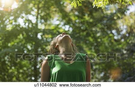 Teenage girl wearing green top looking up, Prague, Czech Republic View Large Photo Image Stock Image - Teenage girl wearing green top looking up, Prague, Czech Republic. Fotosearch