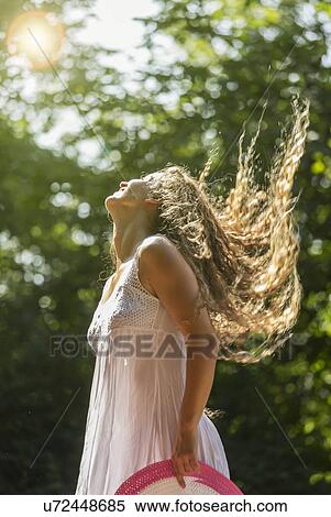 Teenage girl wearing white sundress tossing long hair, Prague, Czech Republic View Large Photo Image Stock Photography - Teenage girl wearing white sundress tossing long hair, Prague, Czech Republic. Fotosearch