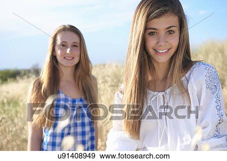 Stock Photo - Teenage girls in field, Tuscany, Italy. Fotosearch
