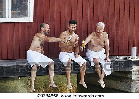 Three men sharing a beer outside sauna View Large Photo Image Stock Photograph - Three men sharing a beer outside sauna. Fotosearch