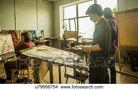 Three young female artists painting in studio View Large Photo Image Picture - Three young female artists painting in studio. Fotosearch