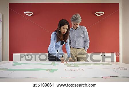 Two architects with blueprints View Large Photo Image Stock Image - Two architects with blueprints. Fotosearch