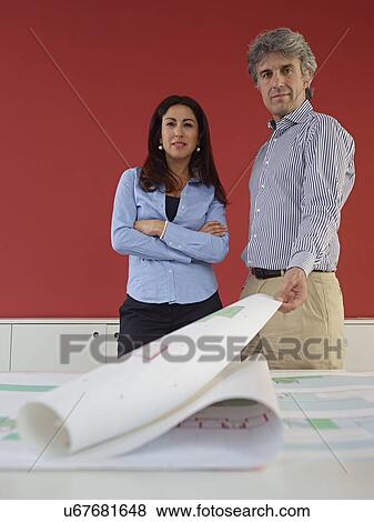 Two architects with blueprints View Large Photo Image Stock Photo - Two architects with blueprints. Fotosearch