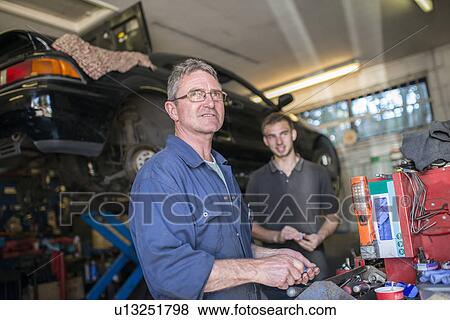 Two mechanics in garage View Large Photo Image Stock Photo - Two mechanics in garage. Fotosearch
