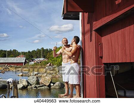 Two men with beers outside sauna View Large Photo Image Stock Image - Two men with beers outside sauna. Fotosearch