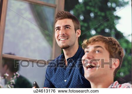 Stock Photograph - Two young men laughing. Fotosearch