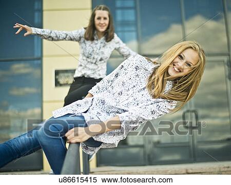 Two young women balanced on railings View Large Photo Image Stock Photography - Two young women balanced on railings. Fotosearch