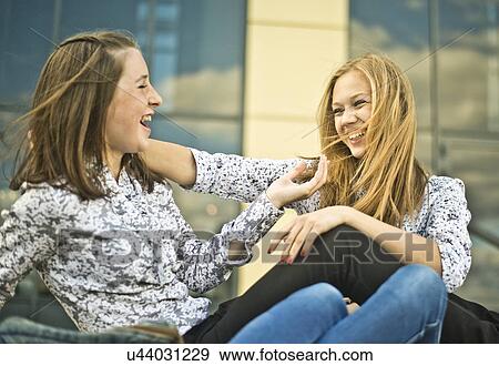 Stock Photo - Two young women flirting and having fun. Fotosearch