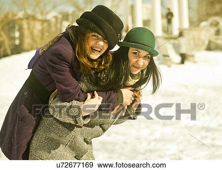 Two young women fooling around in snow View Large Photo Image Stock Photo - Two young women fooling around in snow. Fotosearch