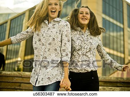 Stock Photo - Two young women jumping. Fotosearch