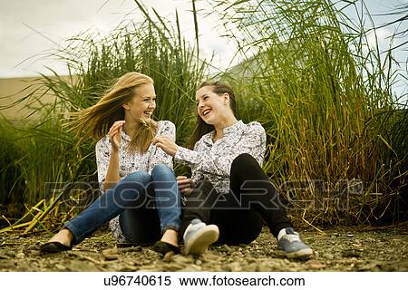 Two young women laughing in breeze View Large Photo Image Stock Photography - Two young women laughing in breeze. Fotosearch