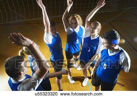 Stock Image - Volleyball team doing high fives. Fotosearch
