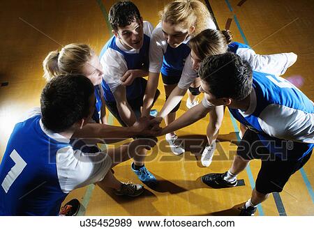 Volleyball team having team huddle View Large Photo Image Stock Photo - Volleyball team having team huddle. Fotosearch