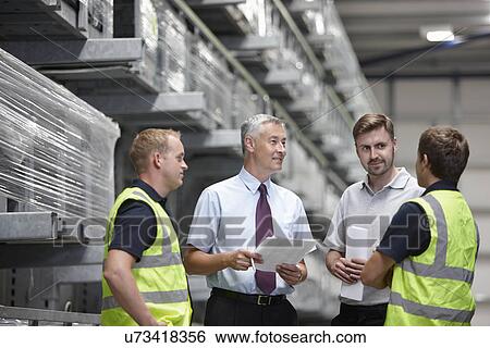 Warehouse workers and manager meeting in engineering warehouse View Large Photo Image Stock Photograph - Warehouse workers and manager meeting in engineering warehouse. Fotosearch