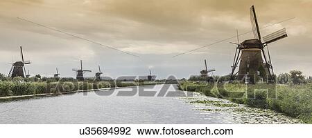 Windmills and canal, Kinderdijk, Olanda, Amsterdam View Large Photo Image Stock Image - Windmills and canal, Kinderdijk, Olanda, Amsterdam. Fotosearch