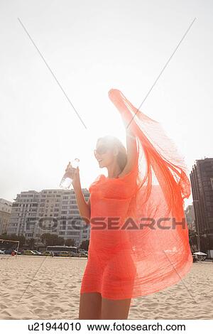 Woman enjoying breeze on beach View Large Photo Image Stock Image - Woman enjoying breeze on beach. Fotosearch