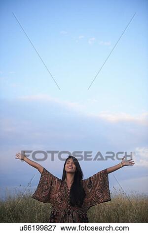Woman enjoying fresh air with open arms View Large Photo Image Stock Photo - Woman enjoying fresh air with open arms. Fotosearch