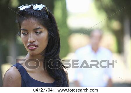 Stock Image - Woman looking down sideways. Fotosearch