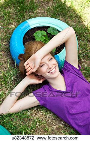 Woman lying on tire, high angle View Large Photo Image Stock Image - Woman lying on tire, high angle. Fotosearch