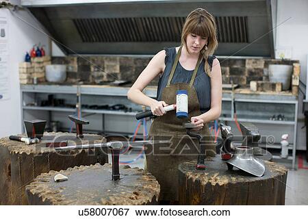 Woman metalworking using hammer View Large Photo Image Stock Photo - Woman metalworking using hammer. Fotosearch