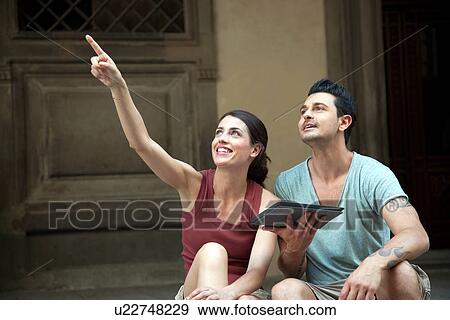 Stock Photo - Woman pointing outside Uffizi Gallery, Florence, Tuscany, Italy. Fotosearch