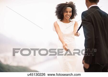 Woman pulling man's tie, Alto Vidigal, Rio de Janeiro, Brazil View Large Photo Image Stock Photograph - Woman pulling man's tie, Alto Vidigal, Rio de Janeiro, Brazil. Fotosearch