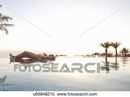 Woman relaxing poolside, Aqaba, Tala Bay, Jordan View Large Photo Image Stock Photography - Woman relaxing poolside, Aqaba, Tala Bay, Jordan. Fotosearch