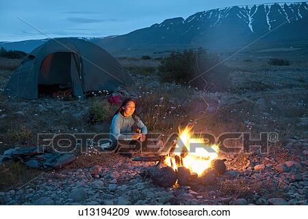 Woman sitting at campfire, Eyjafjordur, North Iceland View Large Photo Image Stock Photo - Woman sitting at campfire, Eyjafjordur, North Iceland. Fotosearch