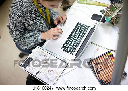 Woman using laptop in jewelery design class View Large Photo Image Stock Photo - Woman using laptop in jewelery design class. Fotosearch