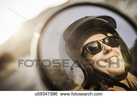 Woman wearing motorbike helmet and sunglasses View Large Photo Image Stock Photograph - Woman wearing motorbike helmet and sunglasses. Fotosearch