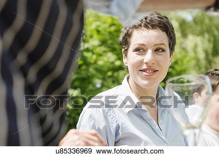 Stock Photo - Woman with short brown hair looking away. Fotosearch