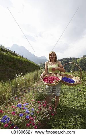Woman with two baskets of flowers View Large Photo Image Stock Photo - Woman with two baskets of flowers. Fotosearch