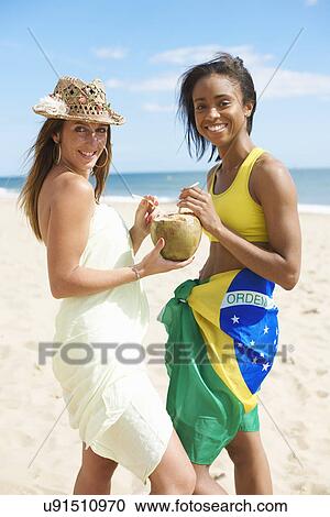 Women sharing coconut water View Large Photo Image Stock Image - Women sharing coconut water. Fotosearch