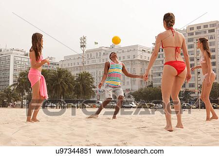 Stock Image - Women watching man bouncing ball on forehead, Copacabana Beach, Rio De Janeiro, Brazil. Fotosearch