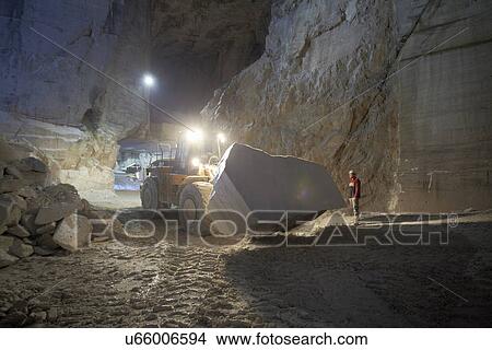 Worker and excavator in marble quarry View Large Photo Image Picture - Worker and excavator in marble quarry. Fotosearch
