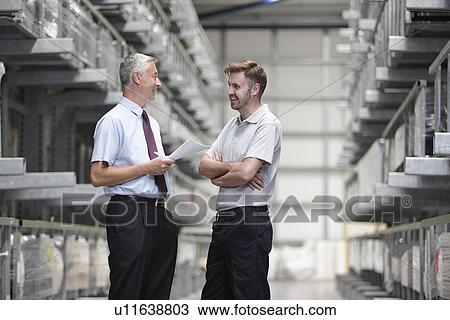Worker and manager checking orders in engineering warehouse View Large Photo Image Stock Image - Worker and manager checking orders in engineering warehouse. Fotosearch