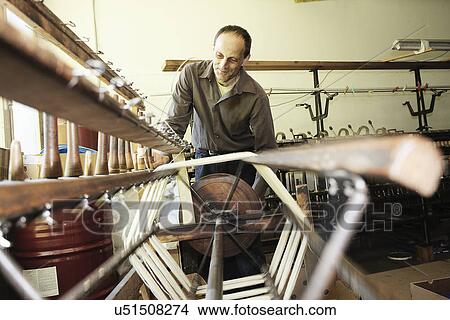 Worker using loom in wool factory View Large Photo Image Picture - Worker using loom in wool factory. Fotosearch