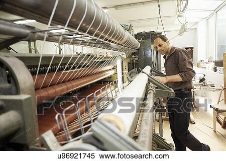 Worker using machine in wool factory View Large Photo Image Stock Photography - Worker using machine in wool factory. Fotosearch