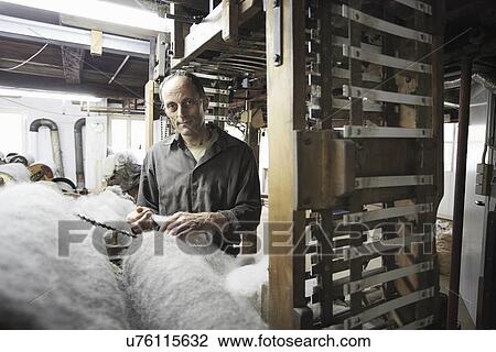 Worker with fleece in wool factory View Large Photo Image Stock Image - Worker with fleece in wool factory. Fotosearch