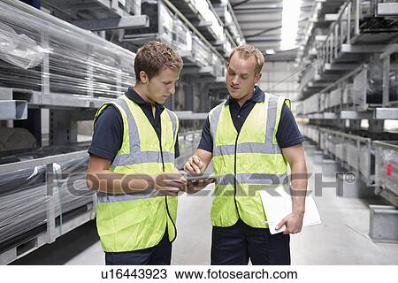 Workers checking orders in engineering warehouse View Large Photo Image Stock Image - Workers checking orders in engineering warehouse. Fotosearch