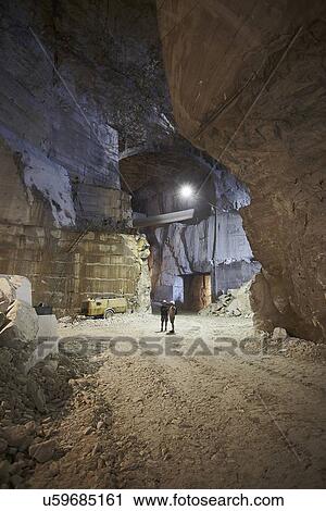 Stock Image - Workers in a marble quarry. Fotosearch