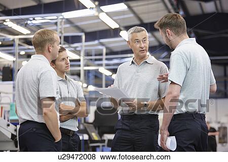 Workers meeting in engineering factory View Large Photo Image Stock Photo - Workers meeting in engineering factory. Fotosearch