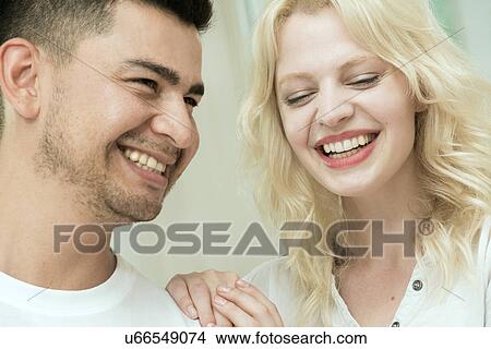 Picture - Young couple laughing. Fotosearch