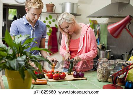 Young couple preparing vegetables View Large Photo Image Stock Image - Young couple preparing vegetables. Fotosearch