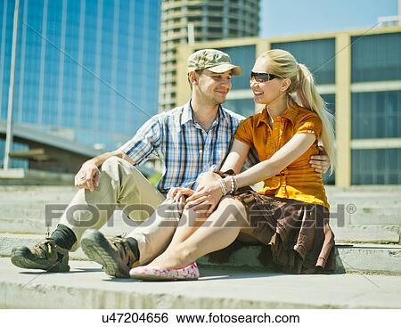 Young couple sitting on steps View Large Photo Image Stock Photograph - Young couple sitting on steps. Fotosearch